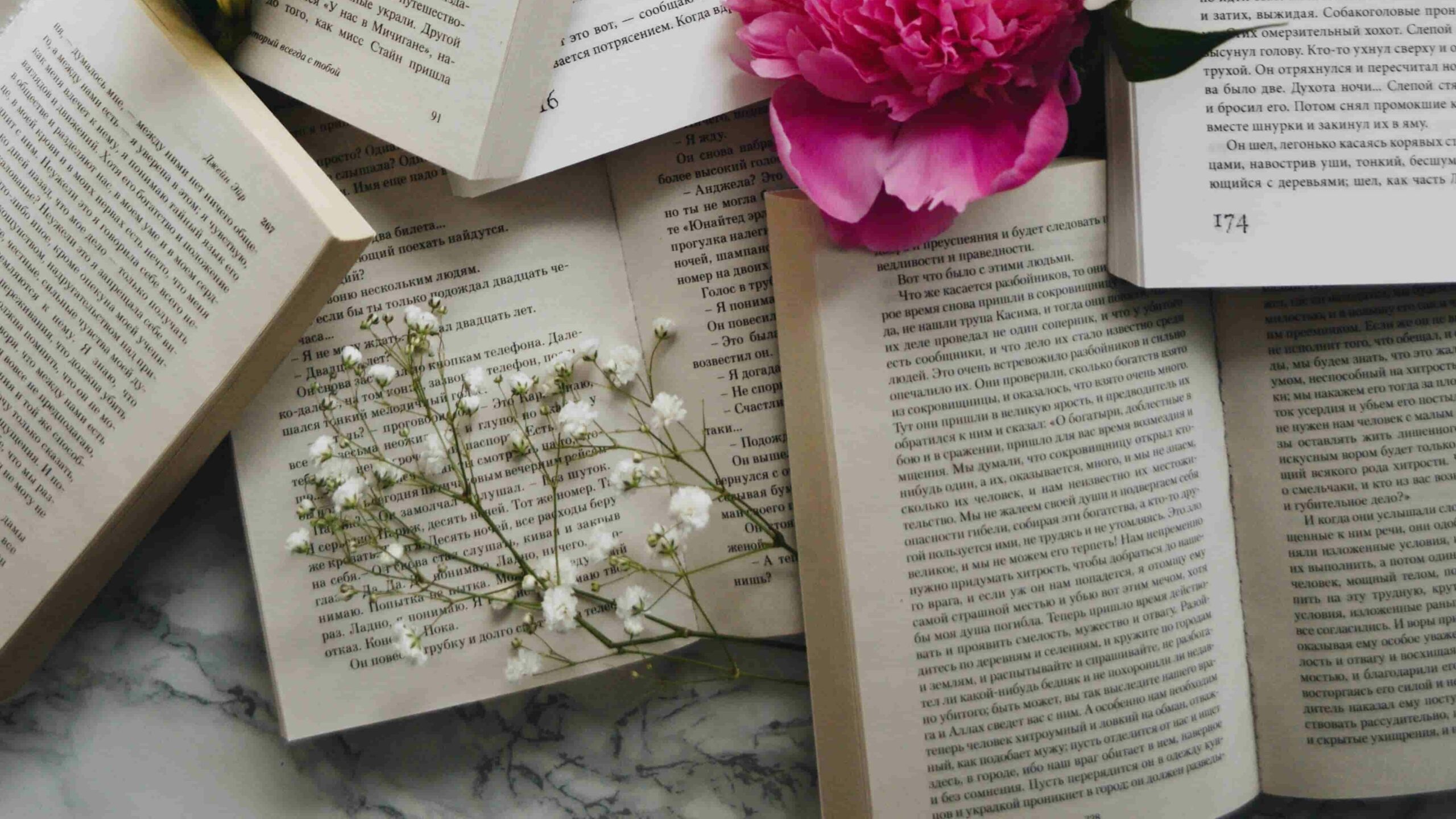 a lot of books with white and pink flowers